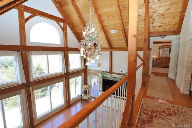a view of an entryway with wooden floor and door