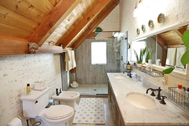 a bathroom with a granite countertop sink mirror vanity and toilet