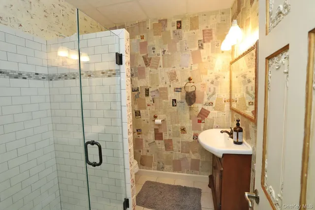 a bathroom with a shower and a sink