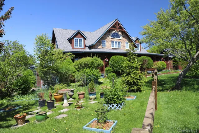 a front view of a house with a yard and fountain