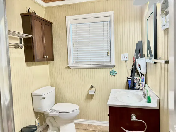 a kitchen with a table chairs refrigerator and cabinets