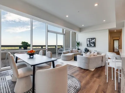 a living room with fireplace furniture and a large window