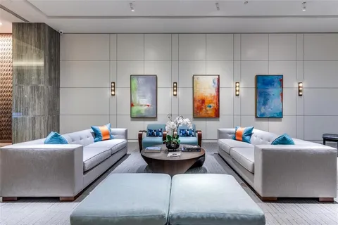 a living room with furniture and a mirror