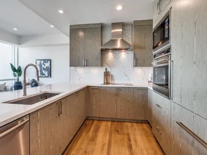 a kitchen with stainless steel appliances a sink and a stove