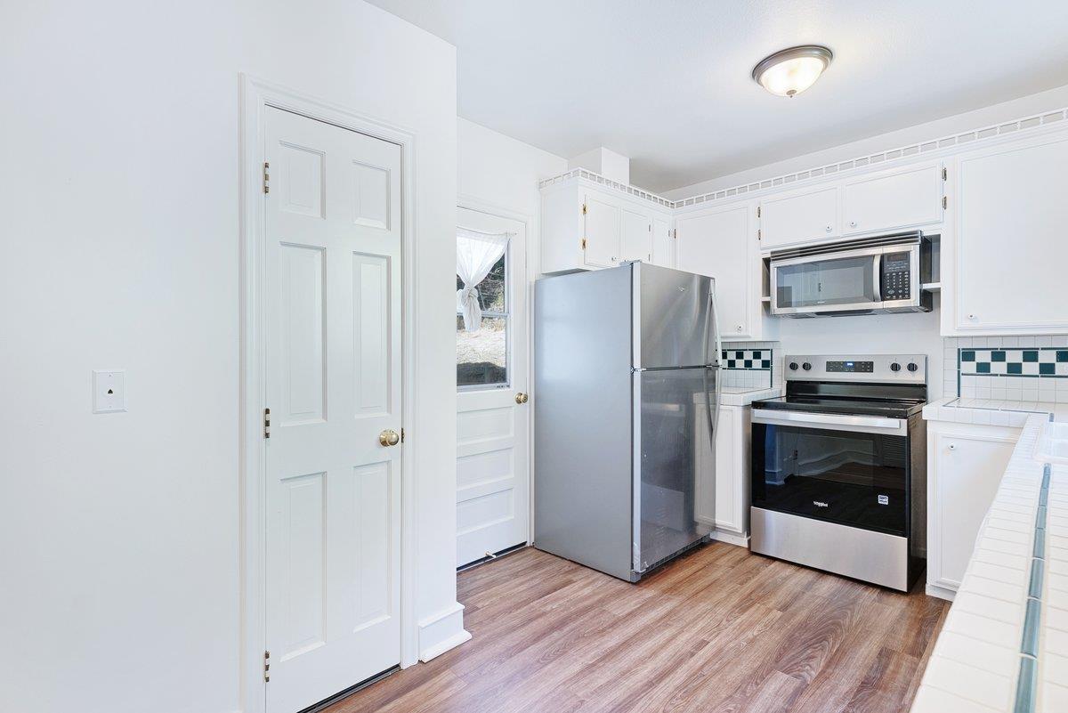 225 Owl Ridge Way Aptos, CA 95003 - Photo 14 of 26 a kitchen with a refrigerator and a stove top oven