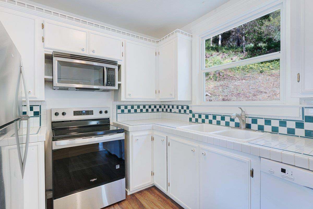 225 Owl Ridge Way Aptos, CA 95003 - Photo 15 of 26 a kitchen with stainless steel appliances white cabinets and a stove