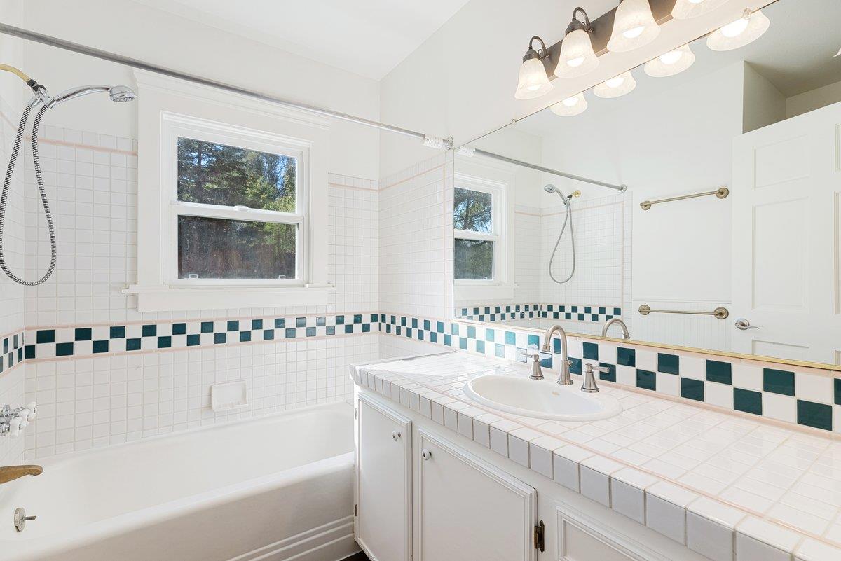 225 Owl Ridge Way Aptos, CA 95003 - Photo 19 of 26 a bathroom with a tub a sink and a mirror