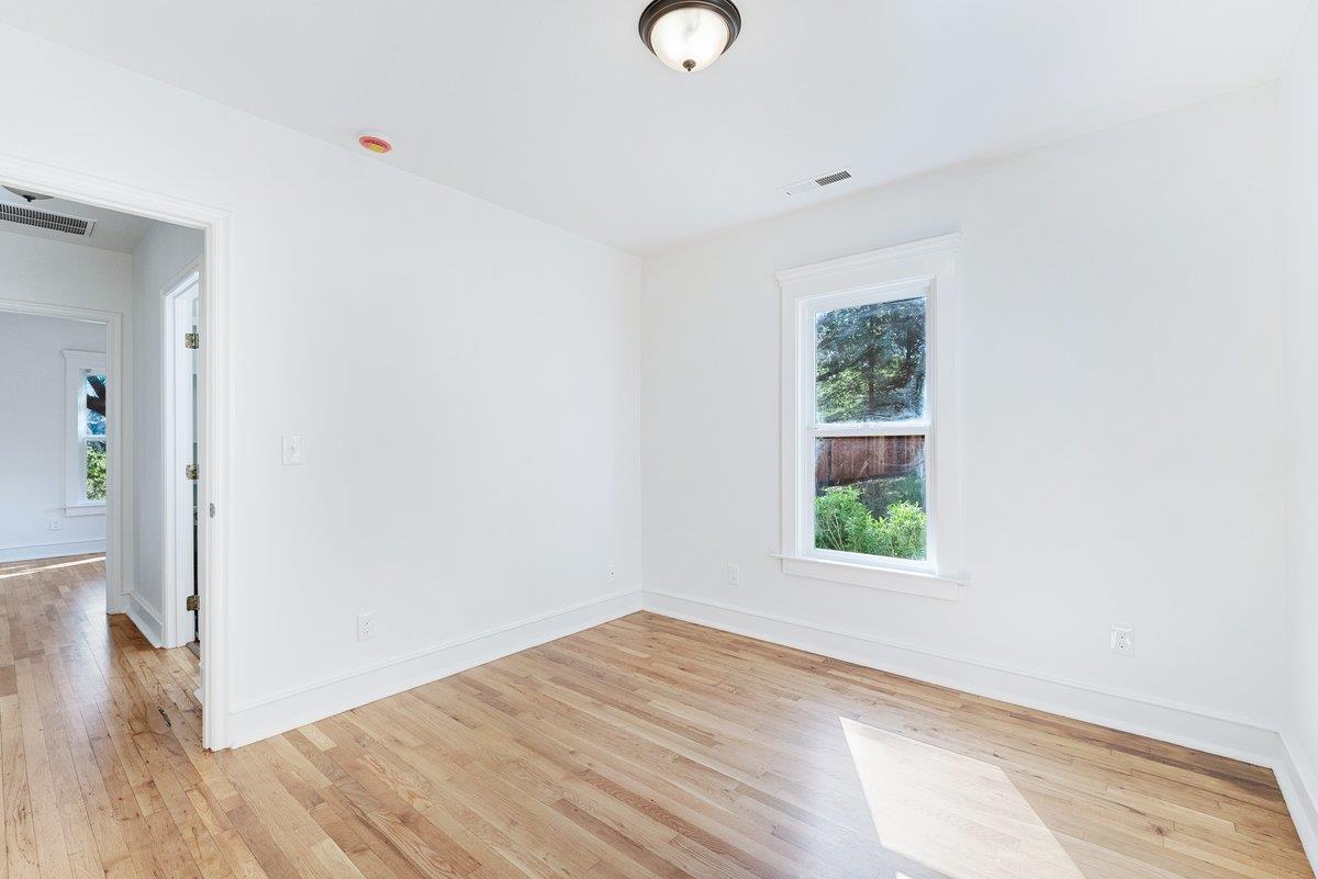 225 Owl Ridge Way Aptos, CA 95003 - Photo 22 of 26 a view of an empty room with wooden floor and a window