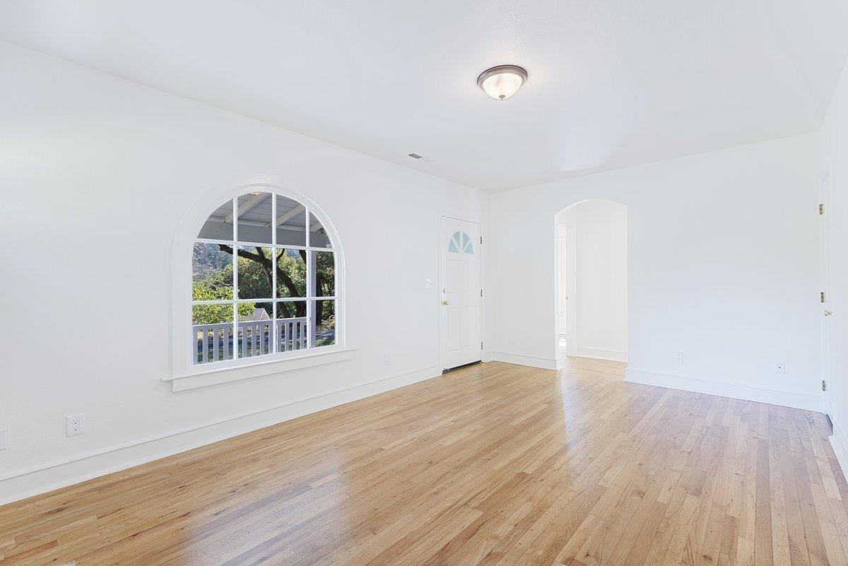 225 Owl Ridge Way Aptos, CA 95003 - Photo 8 of 26 an empty room with wooden floor and windows