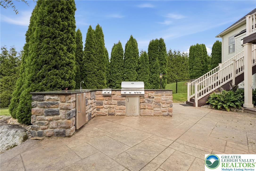 245 East Dell Road Bath, PA 18014 - Photo 85 of 99 An inviting outdoor kitchen on a spacious patio offers ample space for al fresco dining and entertaining.