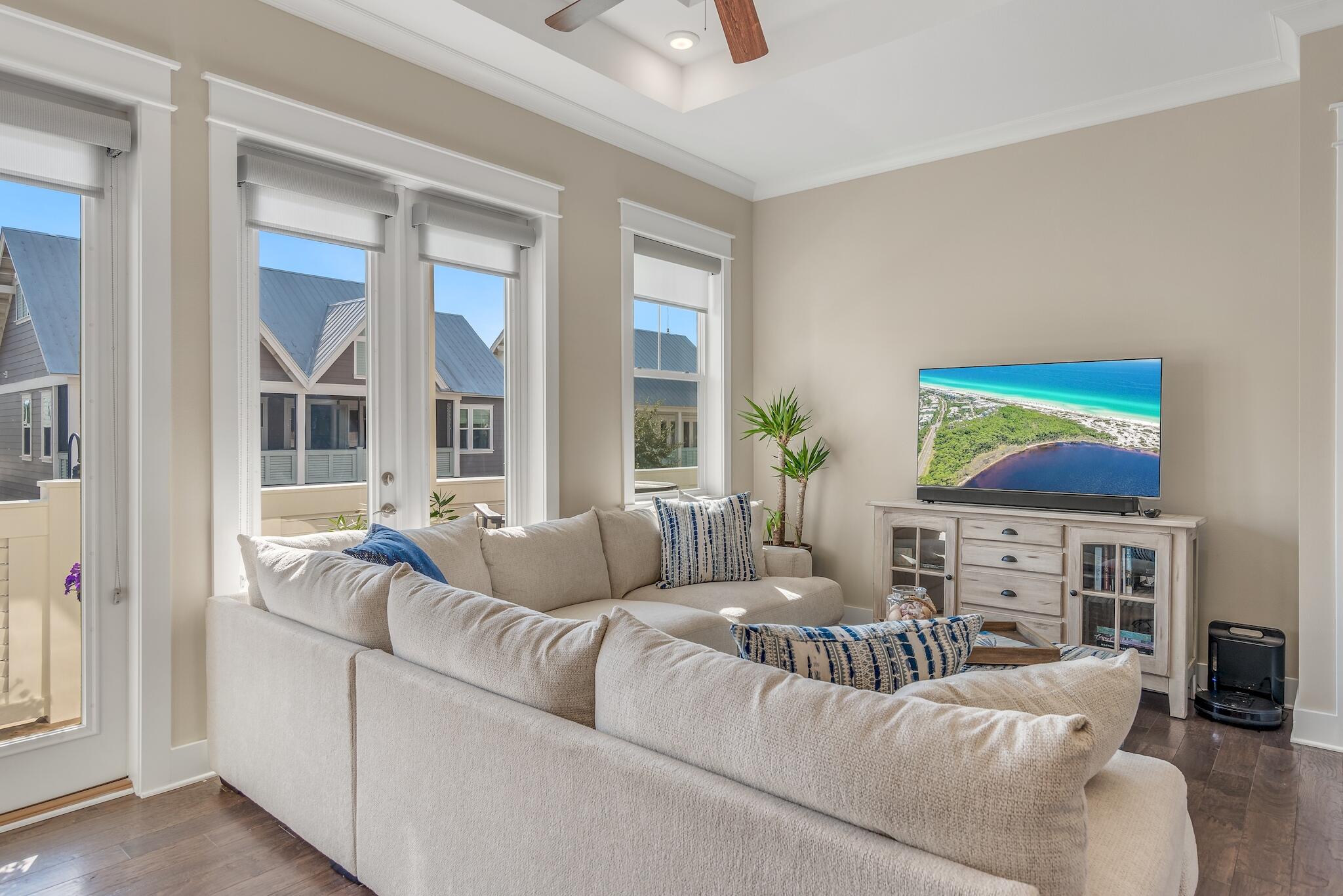 a living room with furniture a fireplace and a flat screen tv