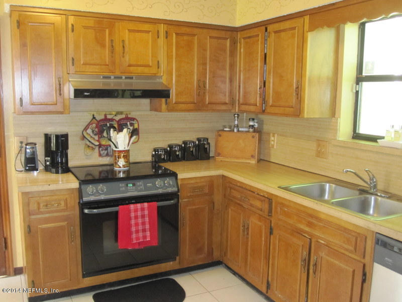 11440 Scott Mill Road Jacksonville, FL 32223 - Photo 11 of 26 a kitchen with stainless steel appliances granite countertop a sink stove and cabinets