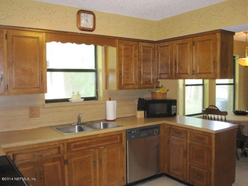11440 Scott Mill Road Jacksonville, FL 32223 - Photo 12 of 26 a kitchen with stainless steel appliances granite countertop a sink and a cabinets
