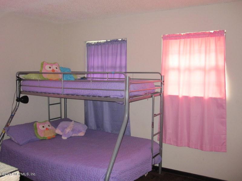 11440 Scott Mill Road Jacksonville, FL 32223 - Photo 14 of 26 a bed room with a bed and a window