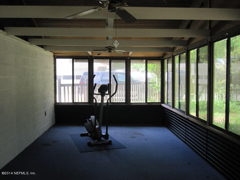 11440 Scott Mill Road Jacksonville, FL 32223 - Photo 22 of 26 a living room with large windows