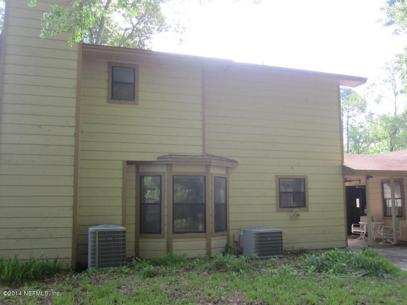 11440 Scott Mill Road Jacksonville, FL 32223 - Photo 25 of 26 a brick house with a small yard and a large window