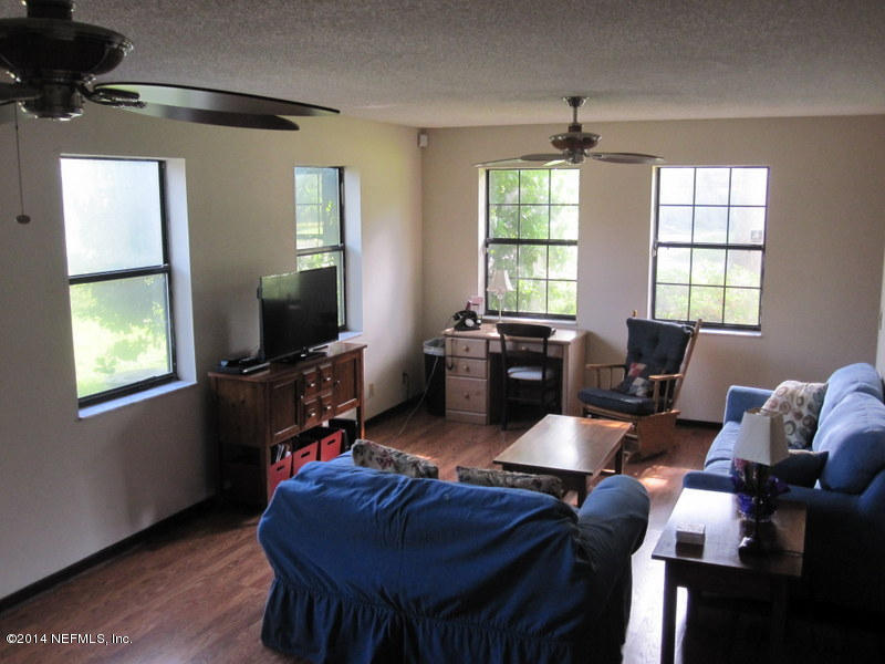 11440 Scott Mill Road Jacksonville, FL 32223 - Photo 8 of 26 a living room with furniture fireplace and window