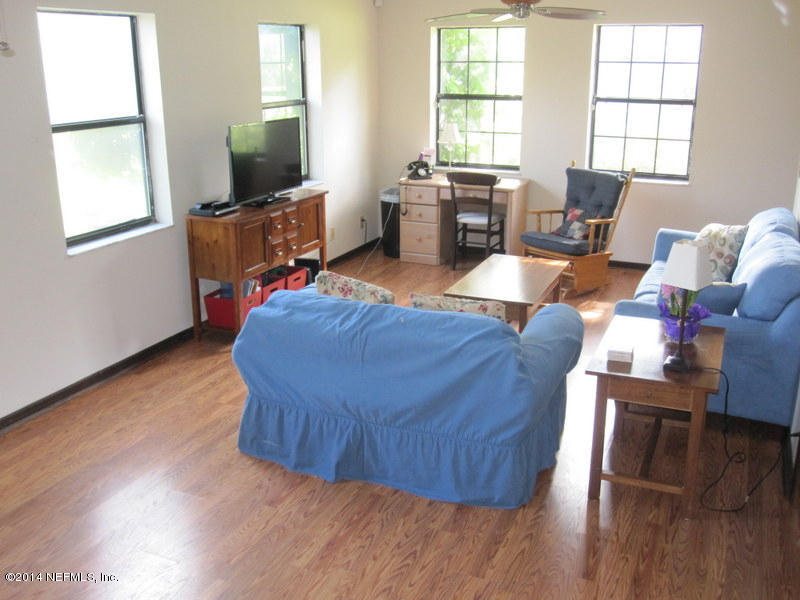 11440 Scott Mill Road Jacksonville, FL 32223 - Photo 9 of 26 a living room with furniture and a flat screen tv