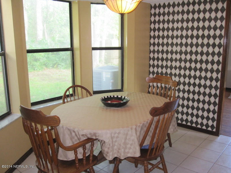 11440 Scott Mill Road Jacksonville, FL 32223 - Photo 10 of 26 a view of a dining room with furniture and window