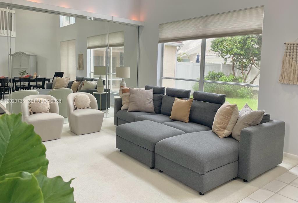 17244 Balboa Point Way Boca Raton, FL 33487 - Photo 24 of 66 a living room with furniture and a large window