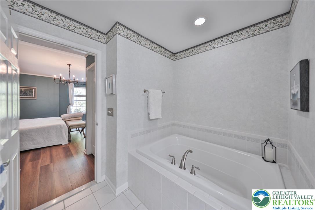 163 Muirfield Way Easton, PA 18042 - Photo 22 of 48 a bathroom with a tub a sink and a large mirror