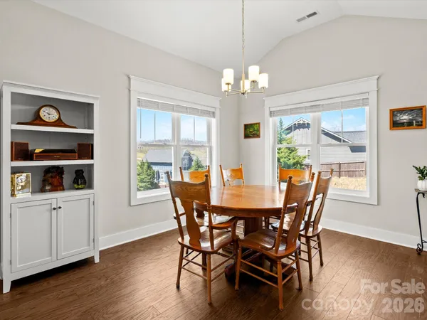 a view of a dining room with furniture wooden floor and chandelier