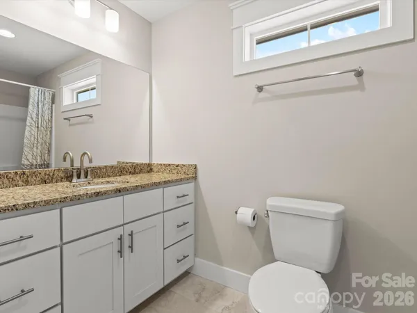 a bathroom with a shower curtain and a toilet