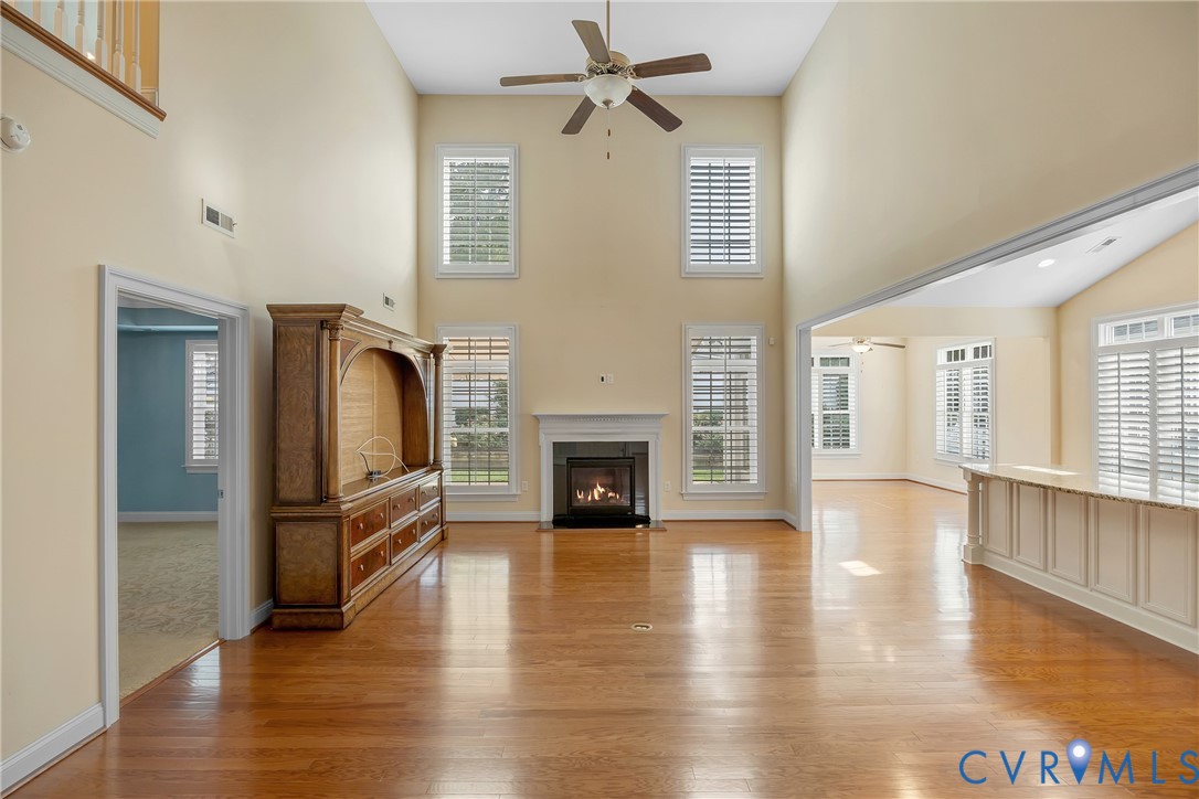 10011 Berry Pond Lane Mechanicsville, VA 23116 - Photo 14 of 47 a view of a livingroom with furniture a fireplace wooden floor and windows