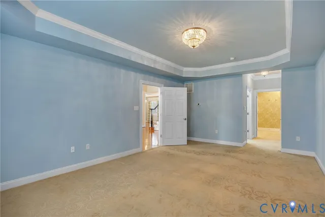 an empty room with windows and chandelier fan