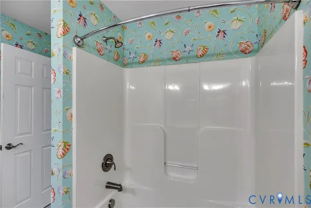 a view of a hallway with wooden floor and brick walls