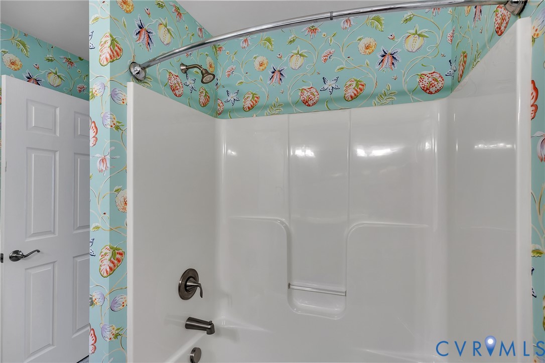 10011 Berry Pond Lane Mechanicsville, VA 23116 - Photo 27 of 47 a bathroom with a sink a mirror and a shower curtain