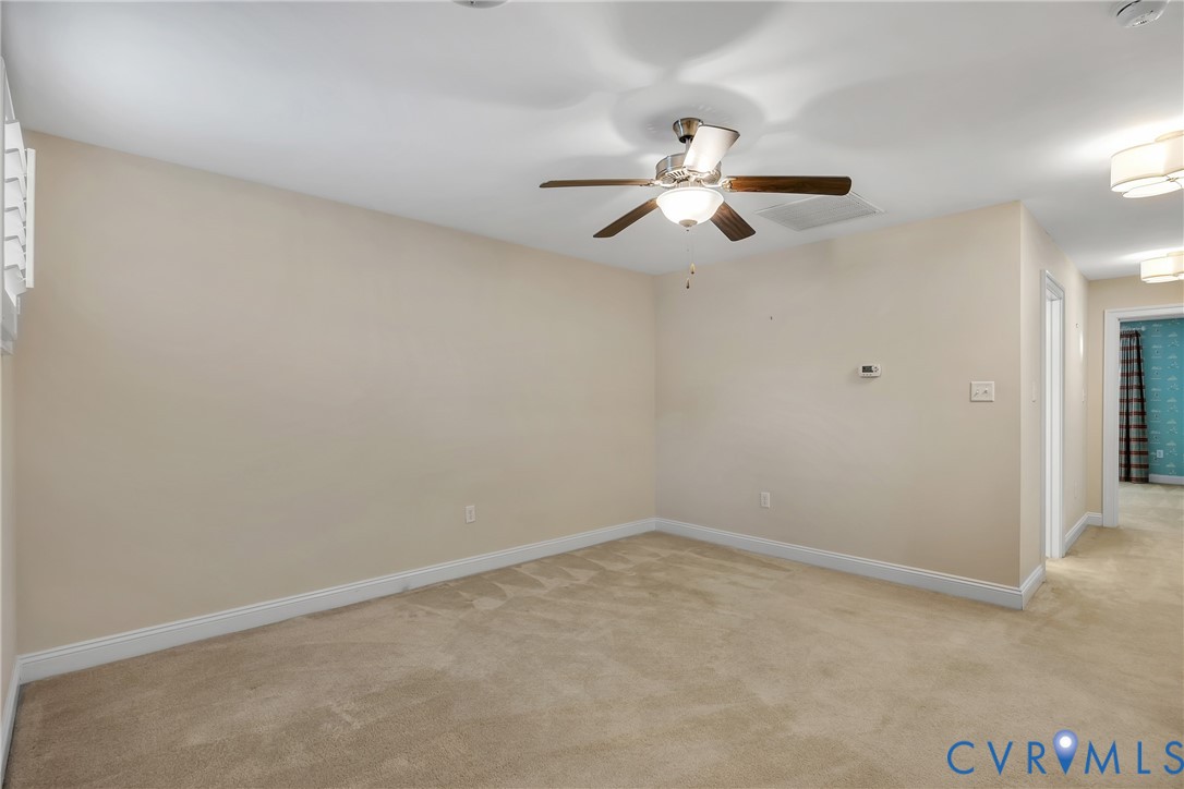 10011 Berry Pond Lane Mechanicsville, VA 23116 - Photo 32 of 47 an empty room with a window and a fan