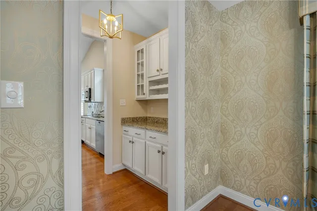 a kitchen with stainless steel appliances granite countertop a sink a stove a refrigerator a microwave a sink and cabinets