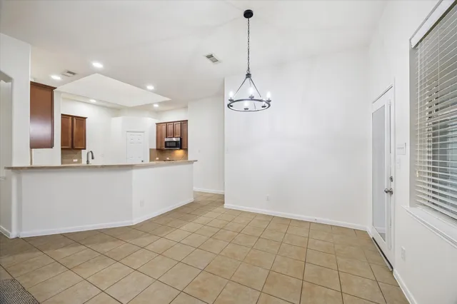 a view of a kitchen with a sink and dishwasher with wooden floor