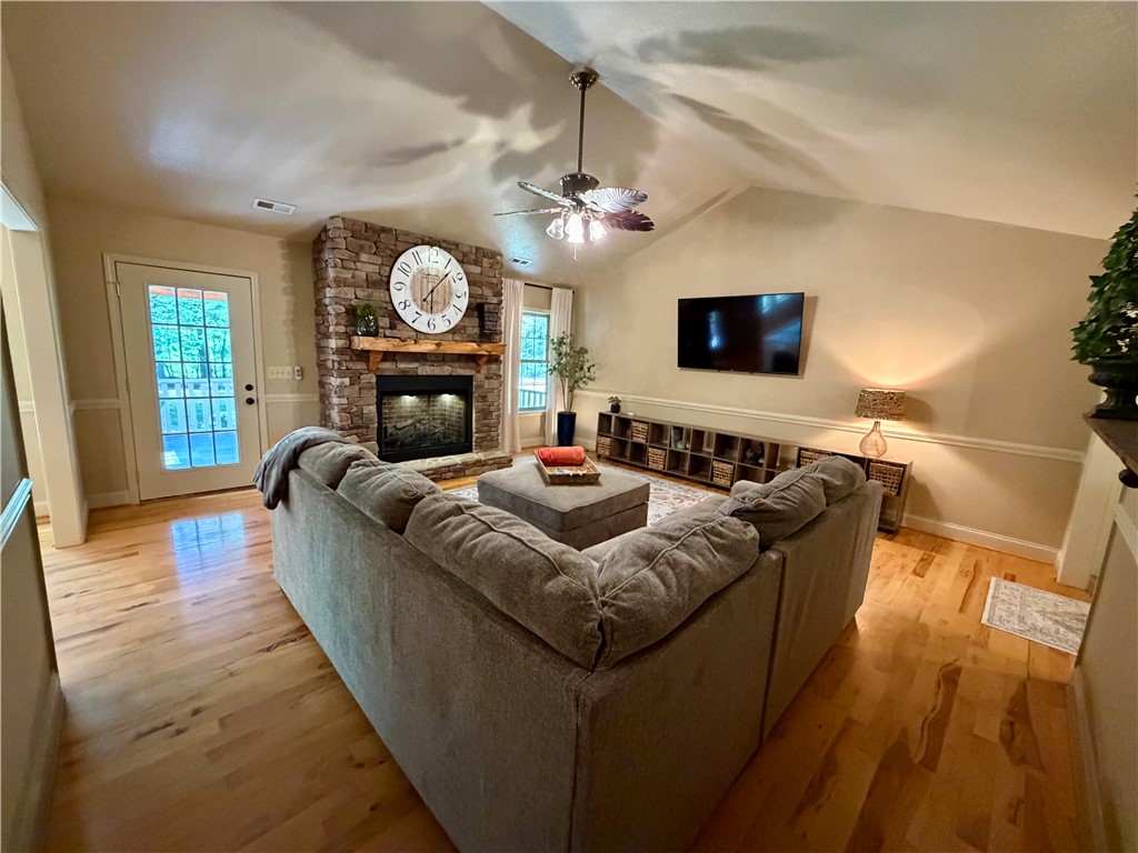 232 Hunters Trail Walhalla, SC 29691 - Photo 9 of 38 This inviting living area boasts rich hardwood flooring and a prominent stone fireplace.