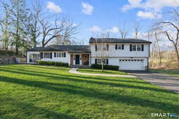 a living room with furniture potted plant and white walls
