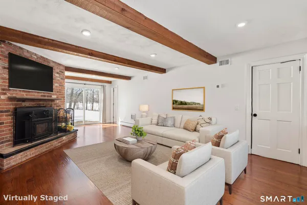 a living room with furniture fireplace and flat screen tv