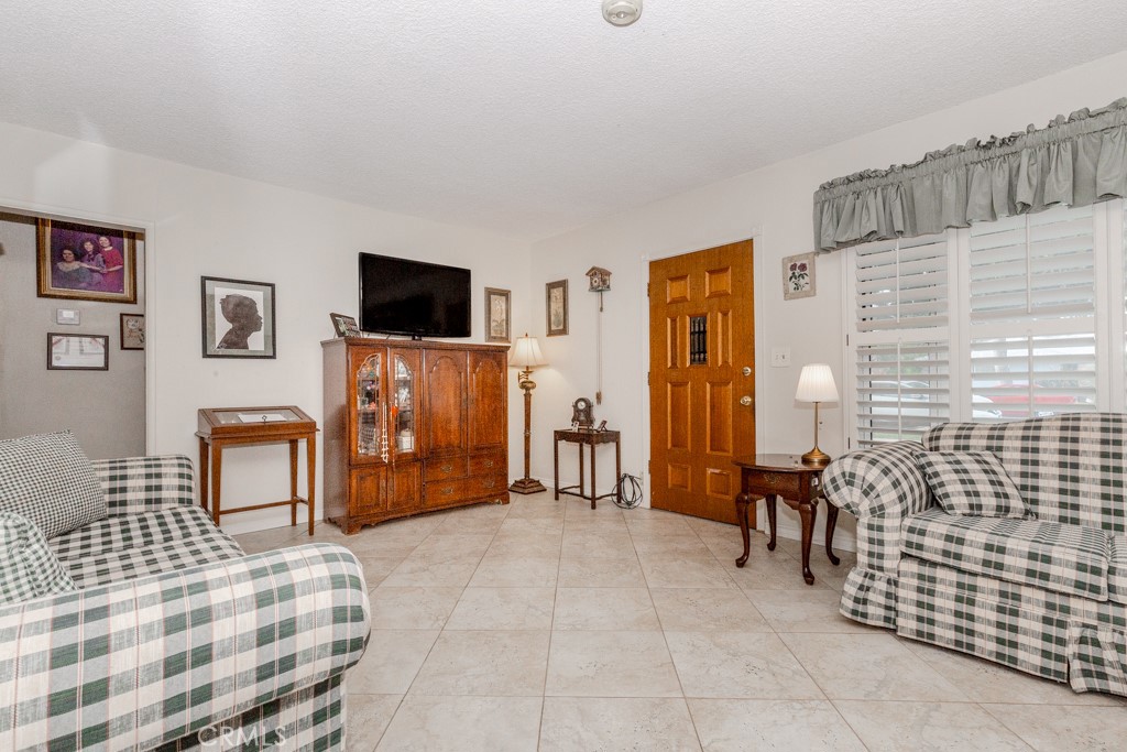4151 Manchester Place Riverside, CA 92503 - Photo 11 of 36 a living room with furniture and a flat screen tv