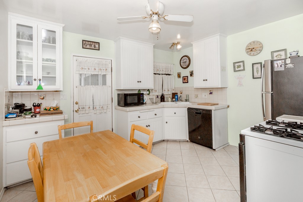 4151 Manchester Place Riverside, CA 92503 - Photo 13 of 36 a kitchen with stainless steel appliances a stove a sink and a refrigerator
