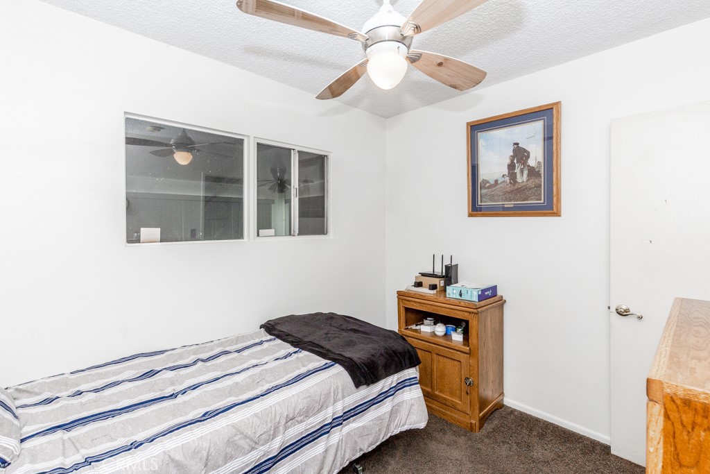 4151 Manchester Place Riverside, CA 92503 - Photo 16 of 36 a bedroom with a bed and a chandelier