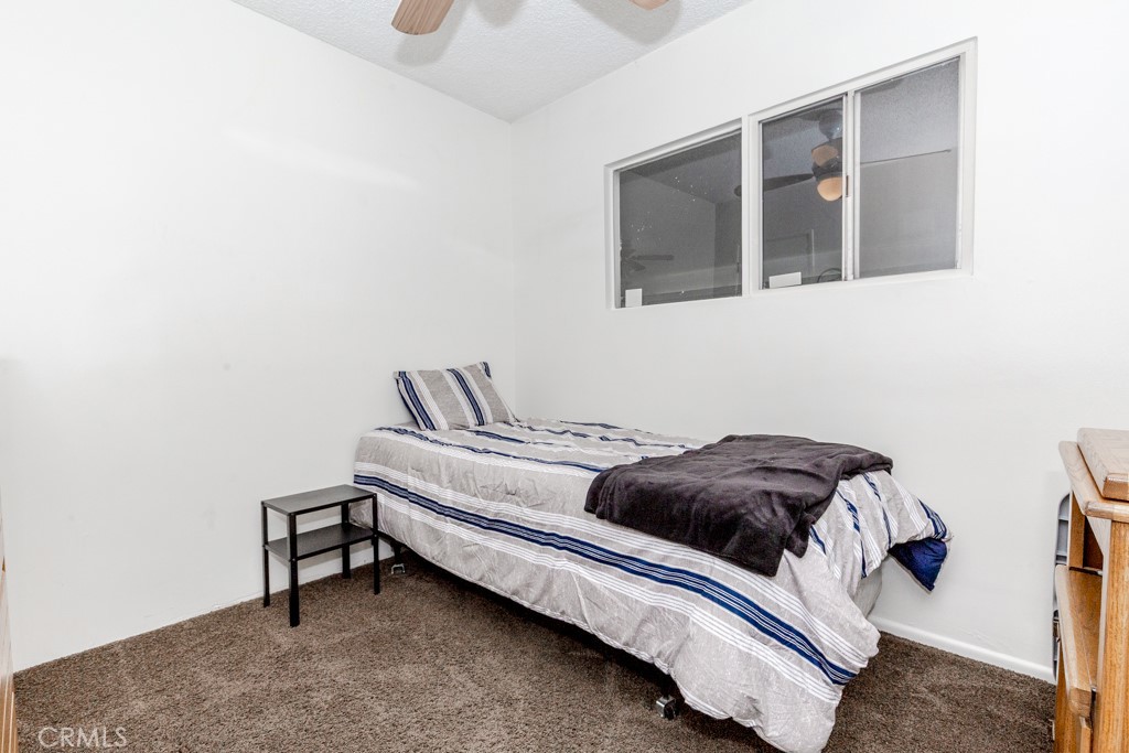 4151 Manchester Place Riverside, CA 92503 - Photo 17 of 36 a bedroom with a bed and cabinet