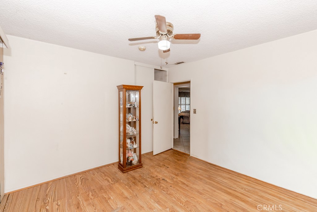 4151 Manchester Place Riverside, CA 92503 - Photo 19 of 36 a view of a room with wooden floor and ceiling fan