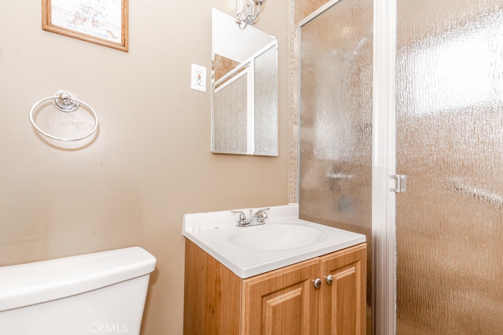 4151 Manchester Place Riverside, CA 92503 - Photo 20 of 36 a bathroom with a sink a toilet and a mirror