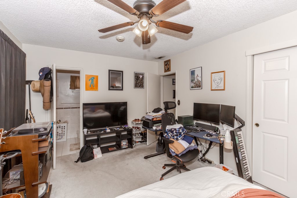 4151 Manchester Place Riverside, CA 92503 - Photo 23 of 36 a living room with furniture and a flat screen tv