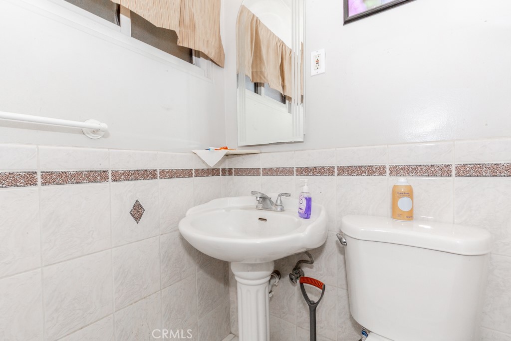 4151 Manchester Place Riverside, CA 92503 - Photo 24 of 36 a bathroom with a sink a toilet and a mirror