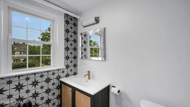 a bathroom with a sink a toilet and window