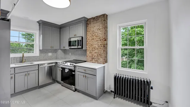 a kitchen that has a sink and a stove top oven