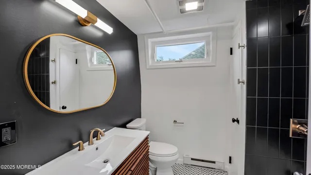 a bathroom with a toilet and a mirror