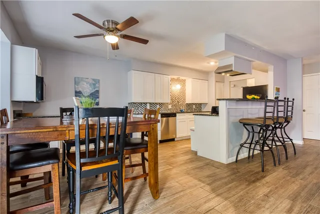 a dining room with furniture and wooden floor