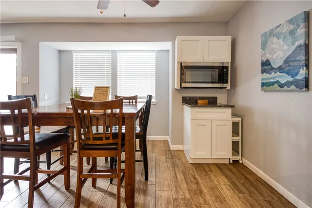 a view of a dining room with furniture and a window